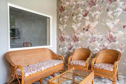 two wicker chairs and a table in a room at Girisadan Boutique Stay in Jaipur
