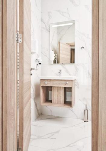 a white bathroom with a sink and a mirror at Evelin Deluxe House in Plovdiv