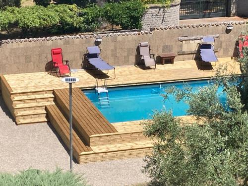 a swimming pool with lounge chairs and a table and a pool at Villa Ginevra in Bagnaia