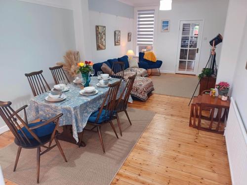 a living room with a table and chairs at Beachside Terrace in Dovercourt