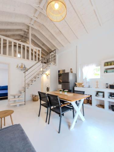 a kitchen and dining room with a table and chairs at Lux Natura in Prinos