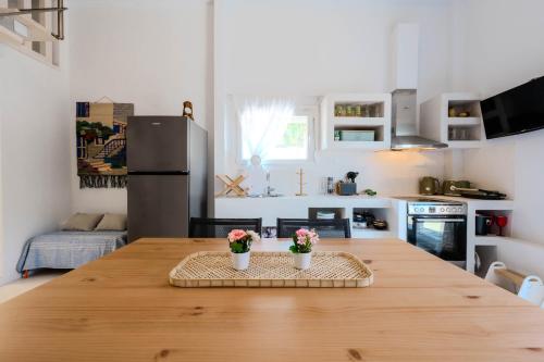 a kitchen with a wooden table with flowers on it at Lux Natura in Prinos