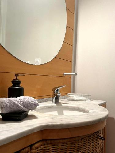 a bathroom with a sink and a mirror at Maison Menadel in Yvetot