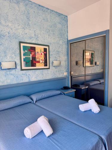 a bedroom with two beds with towels on them at Santa Monica Playa in Salou