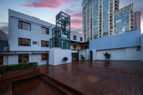 an empty courtyard in a city with tall buildings at True Go Hotel Beijing Jianguomen Pediatric Institute in Beijing