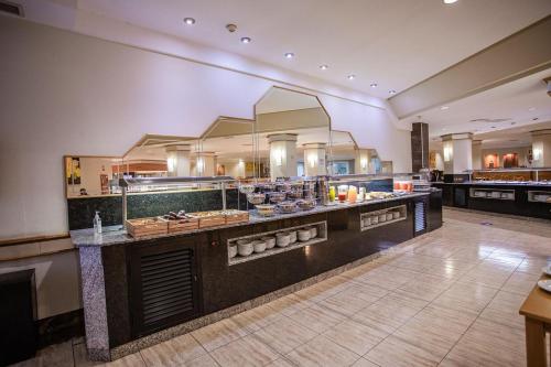 a restaurant with a buffet line in a room at Servatur Don Miguel - Adults Only in Playa del Ingles