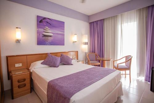 a hotel room with a bed and a table and chairs at Servatur Don Miguel - Adults Only in Playa del Ingles