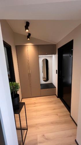 a living room with a wooden floor and a door at High standard and beautiful view in Tennevika