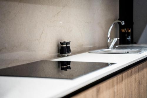 a kitchen counter with a sink and a faucet at The Twin Haven Suites in Hamrun