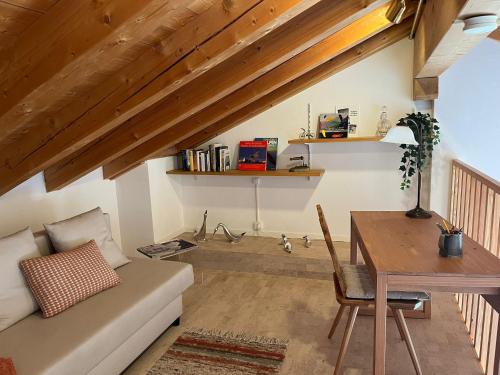 a living room with a couch and a table at Palü in Bever