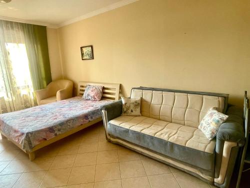 a bedroom with a bed and a couch at Amarena Studio Santa Marina, Sozopol in Sozopol