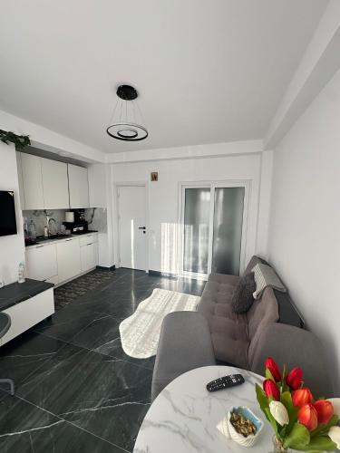 a living room with a couch and a table at MatyMar Black & White in Agigea