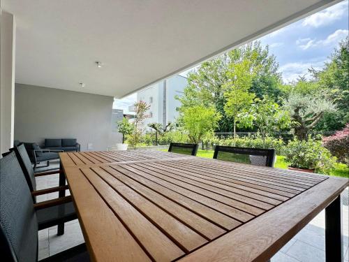 a large wooden table in a room with a large window at RESIDENCE BACO Da SETA in Mestre