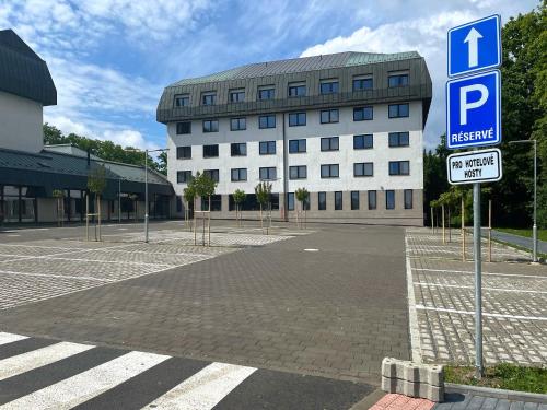 a large white building with a parking sign in front of it at Hotel Globus in Prague