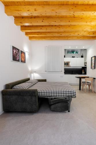 a bedroom with a bed and a couch and a table at Little Suite Bellagio Da Pierina in Bellagio