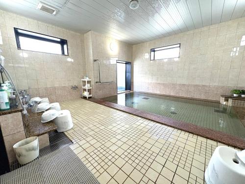 a bathroom with two sinks and a swimming pool at Hotel Route-Inn Niihama in Niihama