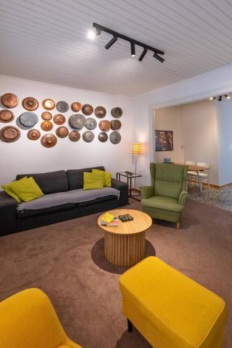 a living room with a couch and a table at Greenhouse - Kalamata Mediterranean Villas in Kalamata