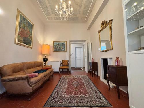 a living room with a couch and a mirror at CAVOUR257 in La Spezia