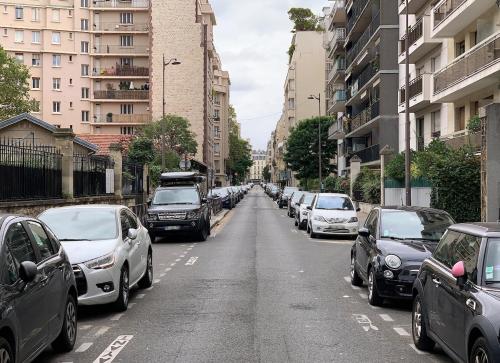 a street filled with parked cars and buildings at Paris 16, Lux Studio - Steps from metro 9! in Paris