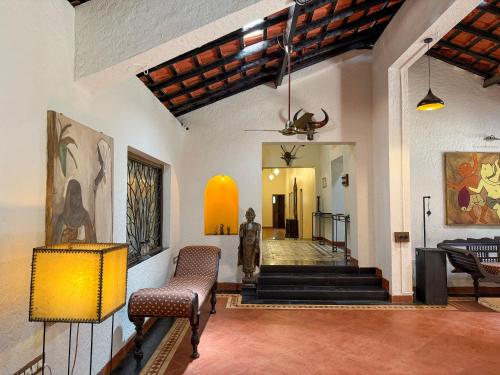 a lobby with a statue in the center of a building at Malkin Hostel in Arpora