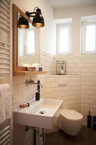 a bathroom with a sink and a toilet and a mirror at Coffee Fellows Hotel Trier in Trier