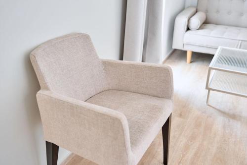 a chair in a living room with a couch at Hotel Ankaa - Adults Only in Porto Cristo
