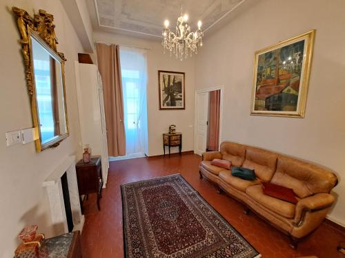 a living room with a couch and a chandelier at CAVOUR257 in La Spezia