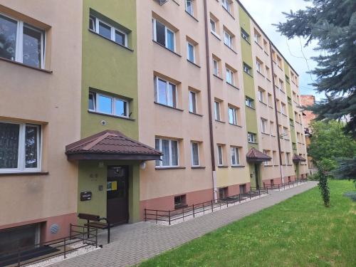 a large building with benches in front of it at Apartament Premium Tarnów 2 in Tarnów