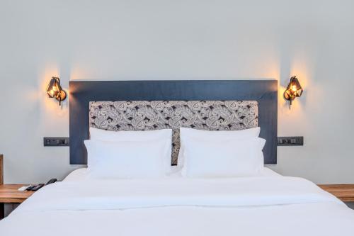 a bedroom with a large bed with two white pillows at Girisadan Boutique Stay in Jaipur