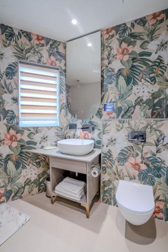 a bathroom with a sink and a toilet at Girisadan Boutique Stay in Jaipur