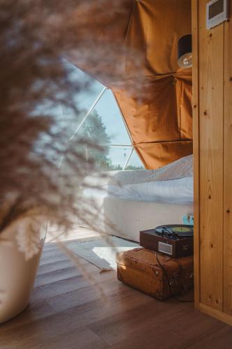 a view of a bedroom with a bed and a window at Heaven Reset Spa Luksusowy Glamping Jacuzzi w Naturze Blisko Warszawy in Korczew