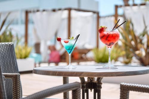 two cocktails sitting on a table on a patio at Hotel Ankaa - Adults Only in Porto Cristo
