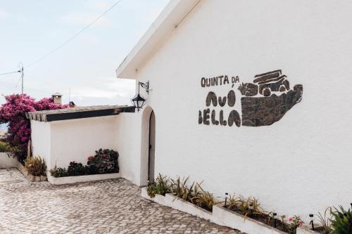 a white building with a sign on the side of it at Quinta da Avó Bella in Buarcos