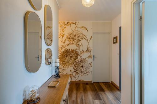 a room with a table and two mirrors on the wall at Le Petit Schatz in Colmar