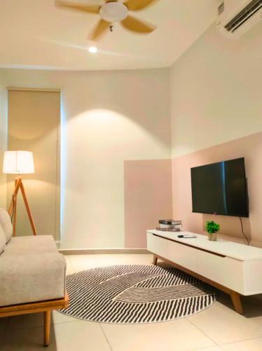 a living room with a flat screen tv on a wall at Paxtonz Seasonal Suites in Petaling Jaya