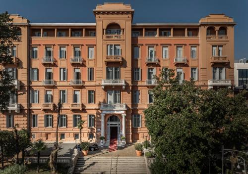 a large brick building with a clock tower at Hotel Imperial - Liburnia in Opatija