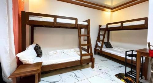 a room with two bunk beds in a room at Pilot Hotel in Alaminos
