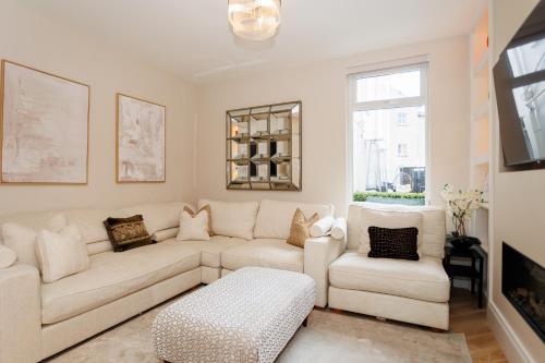 a living room with a couch and two chairs at 111 By Mayfair - Luxurious 12 Bedroom House, Portrush in Portrush