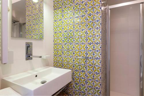 a bathroom with a sink and a shower at Casa Portosalvo, Modica in Modica