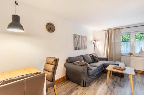 a living room with a couch and a table at Auszeit Sauerland in Olsberg