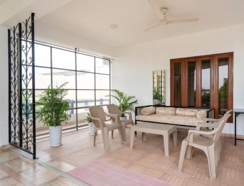 a living room with a couch and a table and chairs at Girisadan Boutique Stay in Jaipur