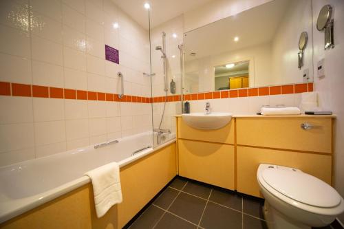 a bathroom with a toilet and a sink and a tub at Barony Castle Hotel in Peebles