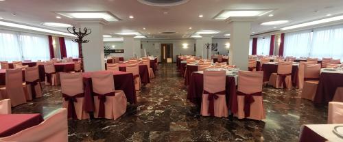 a banquet hall with tables and chairs in a room at Hotel Santomé in Sanxenxo