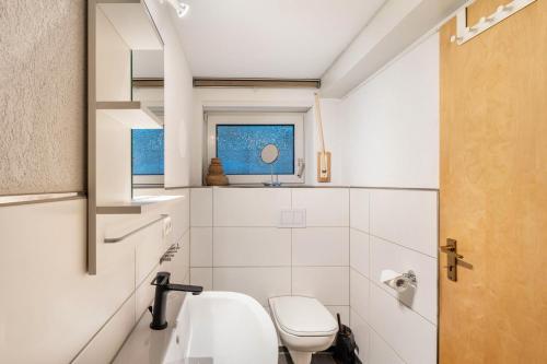 a bathroom with a toilet and a sink at Auszeit Sauerland in Olsberg