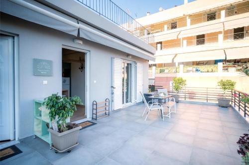 a balcony of a building with a table and chairs at Peacock's Apartments in Piraeus