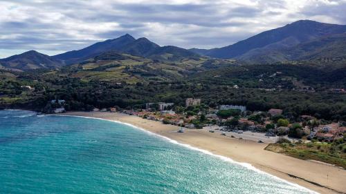 an aerial view of a beach with mountains at Grand Hotel Du Golfe - Spa & Restaurant in Collioure