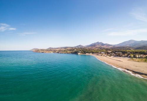 an aerial view of a beach and the ocean at Grand Hotel Du Golfe - Spa & Restaurant in Collioure