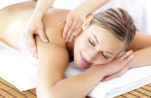 a woman laying on a towel in a massage at Castel Maurn in San Lorenzo di Sebato