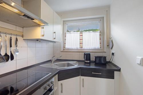 a small kitchen with a sink and a window at Auszeit Sauerland in Olsberg