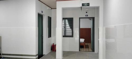 a hallway with a door in a building at Hoàng Yến Hotel Thanh Hoà in Cai Lậy